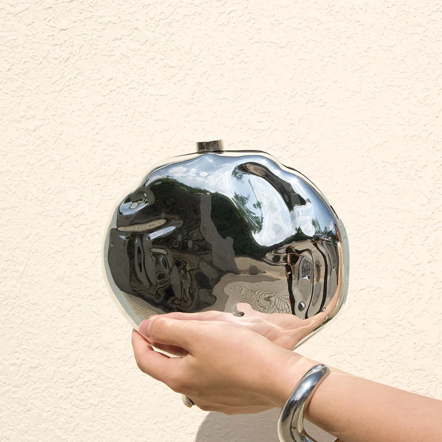 Heavy industry trend irregular meteorite metal feeling hand holding dinner bag mirror cold technology feeling fashion bag