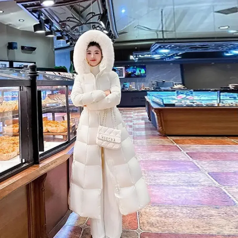 2025 Cappotto lungo da piumino in cotone da donna alla moda invernale nuova da pendolare a vita alta slim fit con cappuccio
