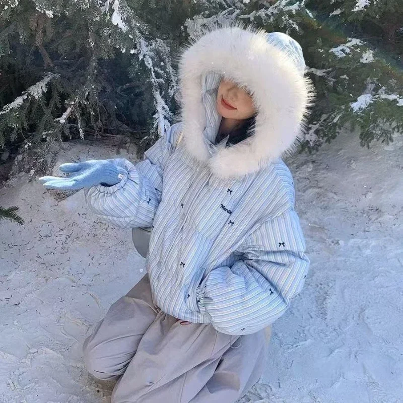 معطف منتفخ مخطط على الطراز الكوري الشتوي لعام 2025 مع ياقة من الفرو وعقدة على شكل فيونكة عازلة سميكة سترة قصيرة بقلنسوة للنساء