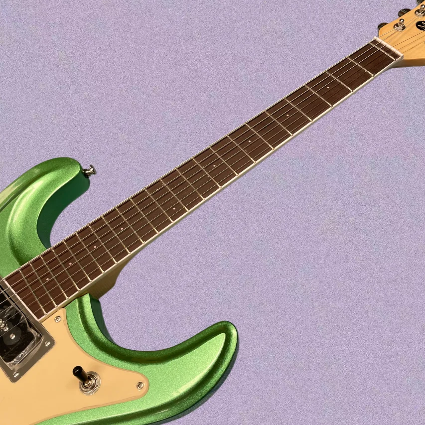 Bright green 6-string electric guitar with vintage vibrato systemguitars, a collector's favorite retro electric guitarra