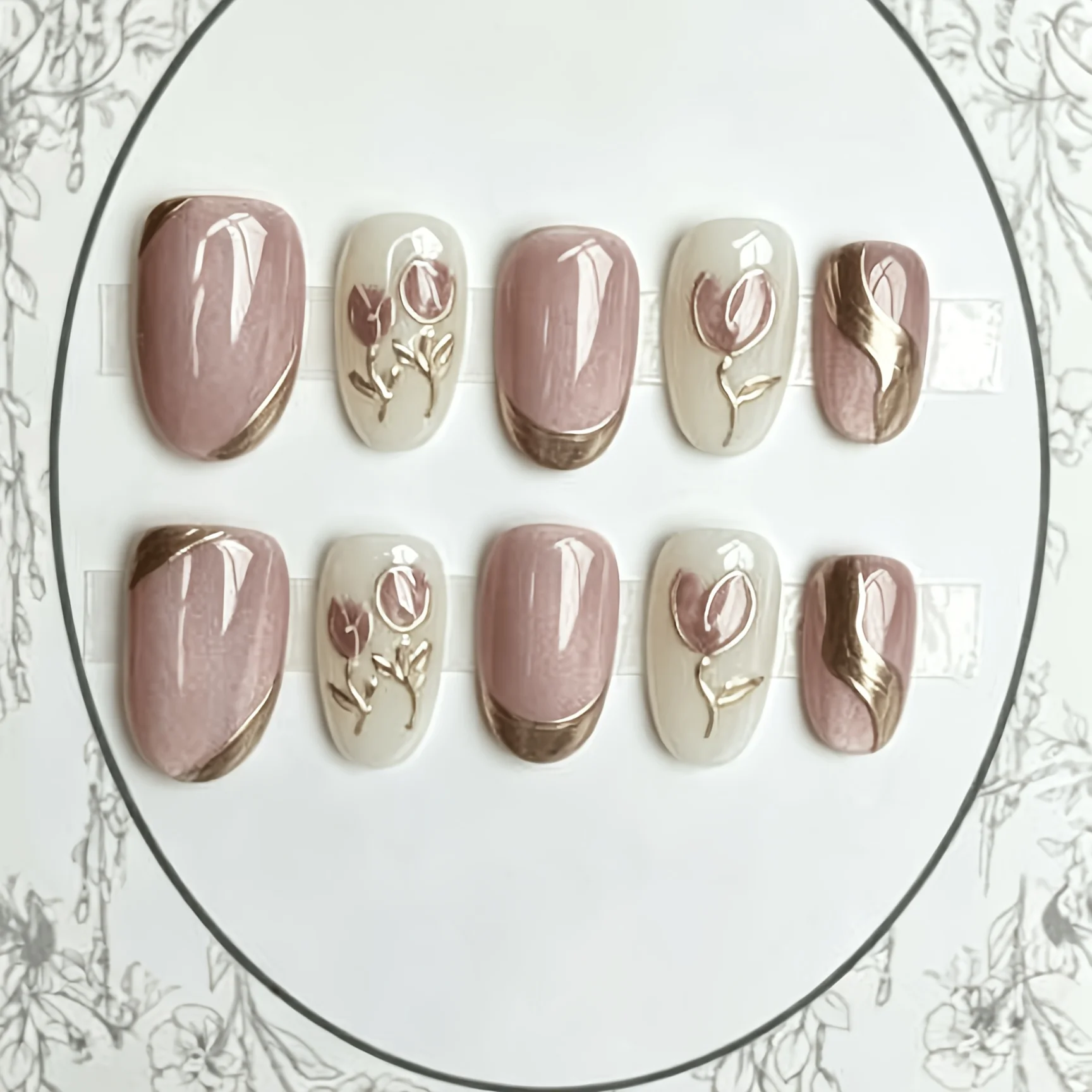10 Pieces of Handmade Press-On Nails, Featuring Pink and White Base Colors with Interspersed Gold Line Flowers and Pearl Accents