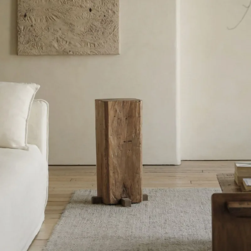 Sculpture of a pillar in the ancient style at the base of a solid wooden pier