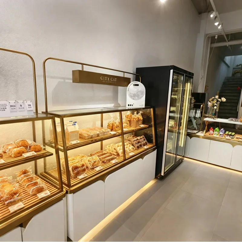 

custom.Minimalist Bakery Shop with Gold-framed Glass Display Cases Packaged Breads and Pastries.
