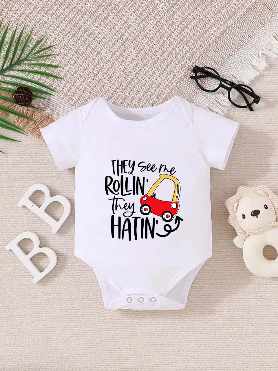 Playful letter-printed baby short-sleeve triangle bodysuit. Button closure for easy dressing, machine washable