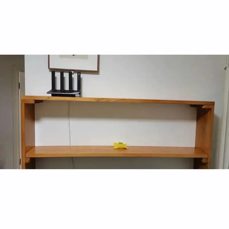 

Storage rack behind the sofa, narrow against wall behind door, bookshelf on ground, extremely narrow