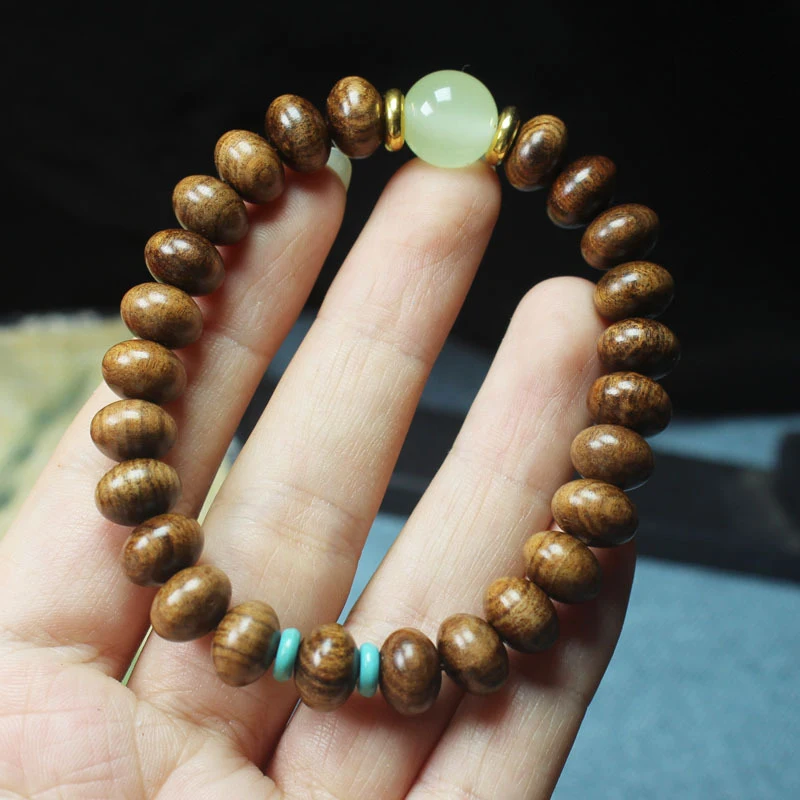 

Браслет из черного палисандра, сандалового дерева и эбенового дерева с бусинами-абакусами и светящимися камнями, буддийские бусины.