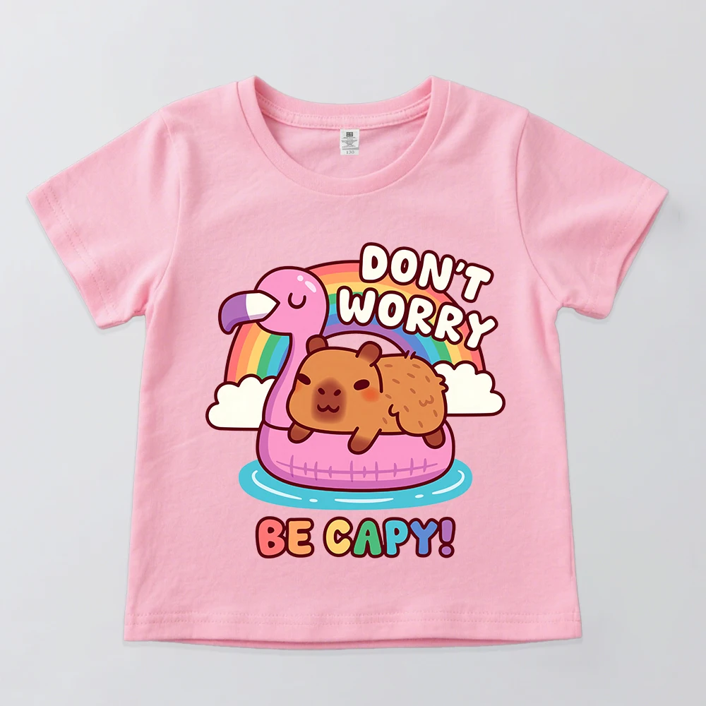 Camiseta de algodón de manga corta para niños y niñas con estampado de capibara lindo relajado en flotador de flamenco, diseño 'Don't Worry Be Capy', informal de verano