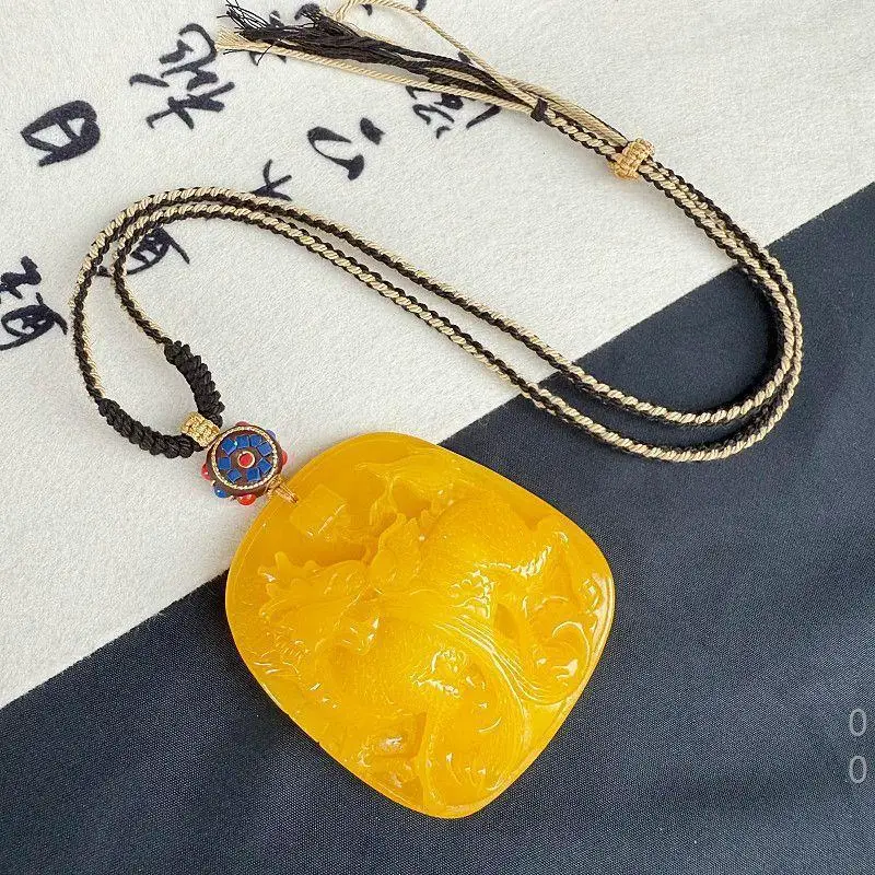 Chicken oil yellow carved qilin mythical beast amber pendant with an extremely long chain, offering a light luxury niche  and h