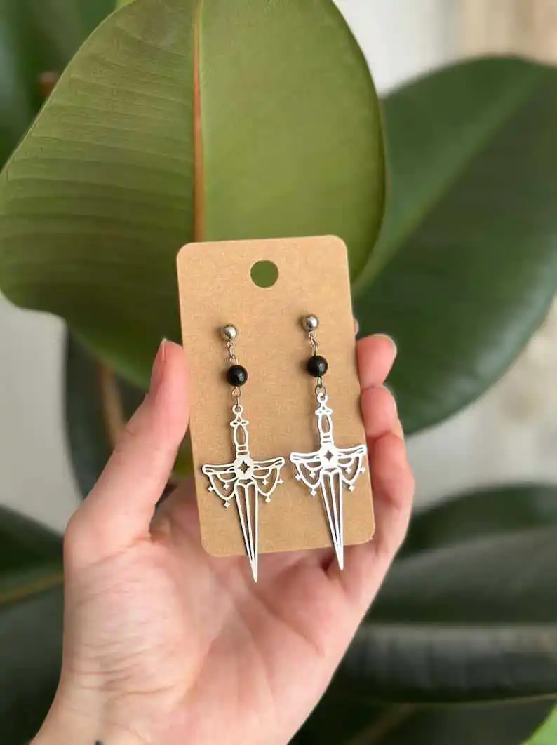 

Hollow sword earrings, engraved design, silver color, brass, black beads, mysterious, sword of Kriss, goddess,ear hook for women