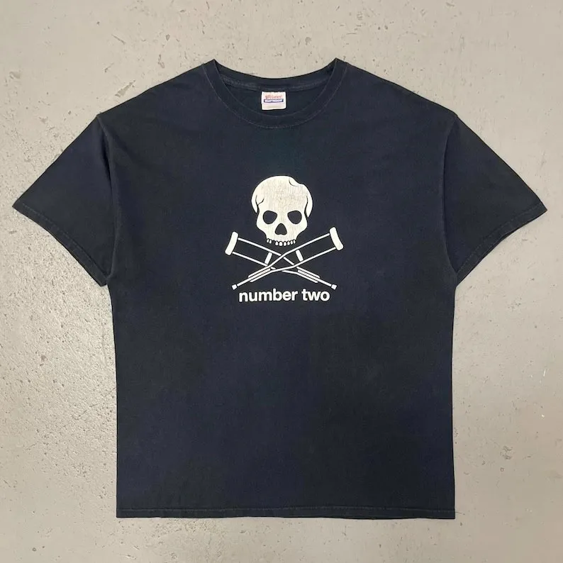 

Vintage Skull Crutches Number Two Graphic T-Shirt Dark Humor Art Tee for Rebellious Trendsetters and Niche Design Enthusiasts
