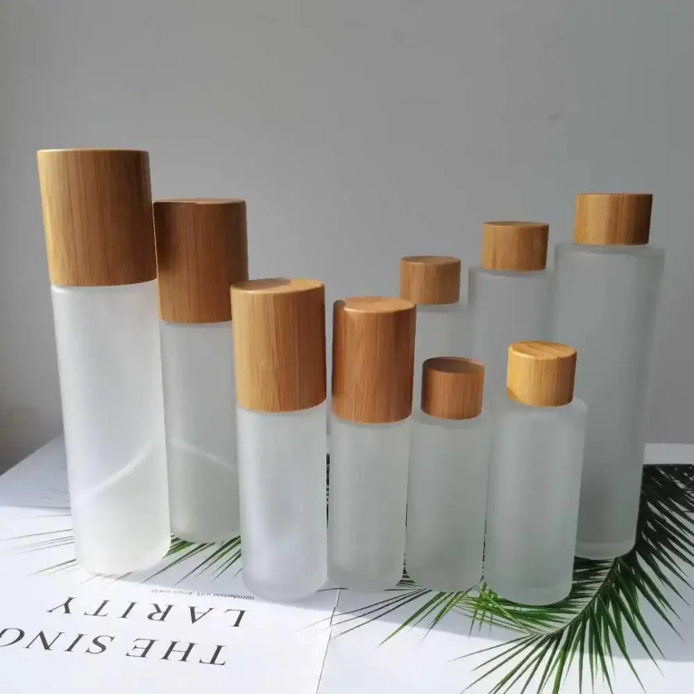 

Frosted Glass Bottles for Cosmetics Bottles with Bamboo Lid Covered spray bottle mist lotion bottles with bamboo wooden pump