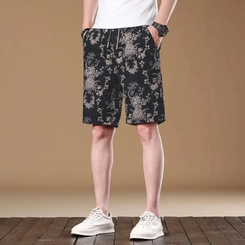 Casual summer floral shorts for men, loose fit with drawstring, simple American retro-style beach pants.