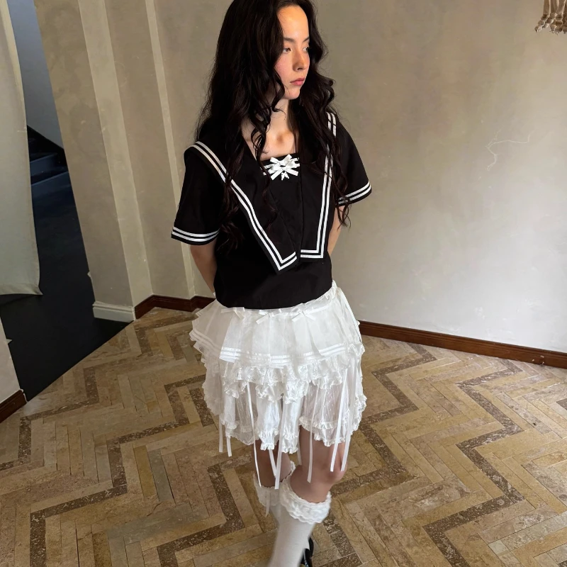 2025 الربيع الصيف الخريف الأبيض القوس لطيف المرأة مطوي تنورة قصيرة التصميم الأصلي الحلو شاش شفاف ضرطة الستار السيدات