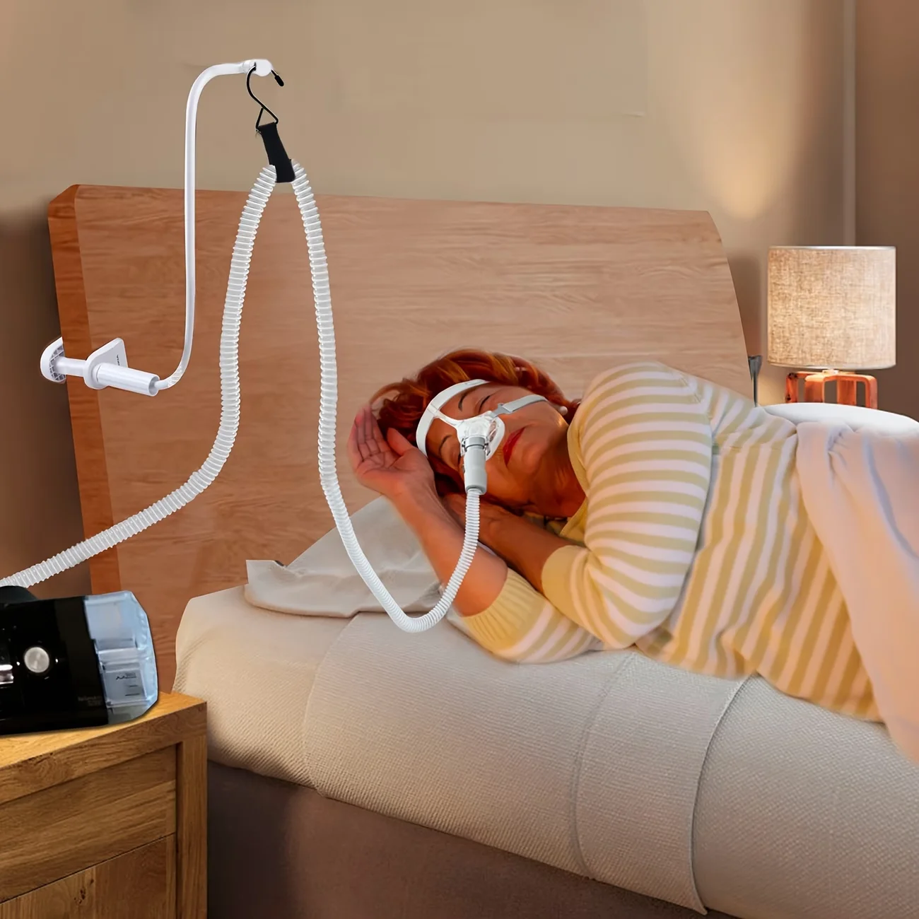 a bed-mounted hose hanger preventing tangling and blockages, holding air hose aloft away from face and arms for restful sleep