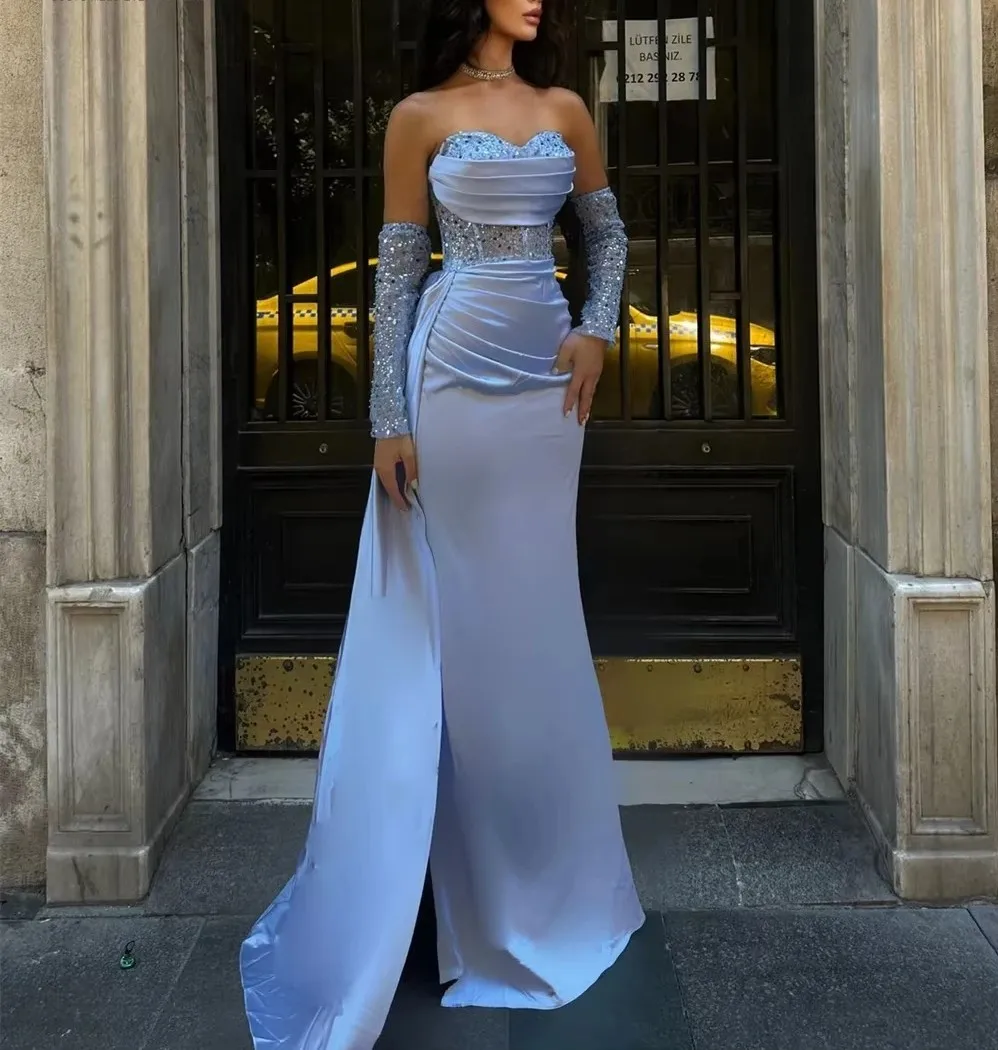 ชุดราตรีสีน้ำเงินโมเดิร์น ปี 2026 แบบคอวี แขนยาว ประดับเลื่อม จับจีบ ชายกระโปรงยาว  เหมาะสำหรับงานพรอม งานประกวด งานปาร์ตี้คริสต์มาส