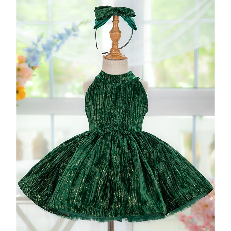 Stylish and luxurious dark green baby girl dress in sparkling velvet fabric suitable for a first birthday party New Year dress