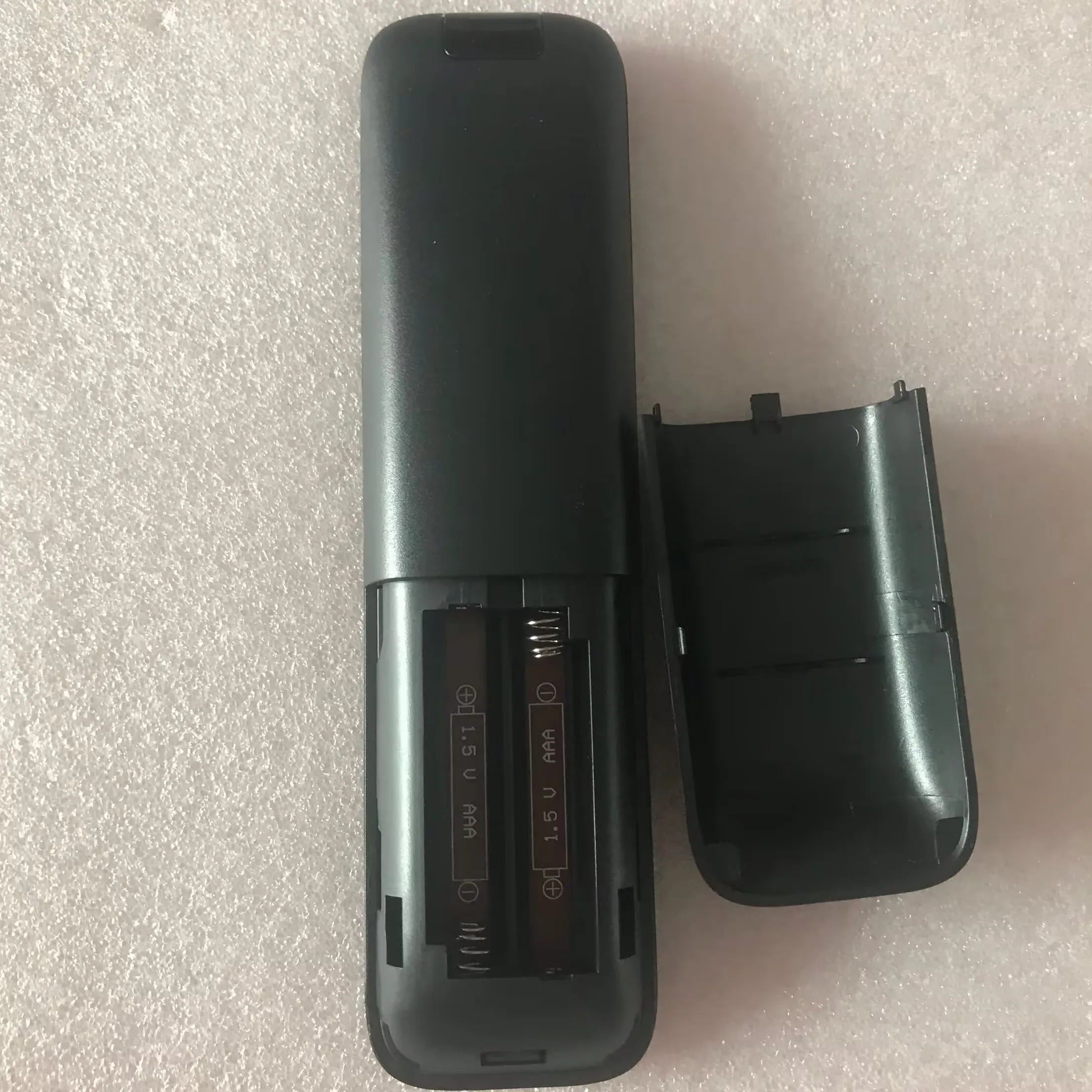 Original remote control for Teufel CINEBAR DUETT soundbar with subwoofer volume and sound effect mode buttons.