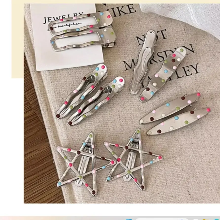 

Colorful polka dot hairpin for girls with frizzy hair on the forehead. Cute and cool teenage style beak-shaped hairpin.