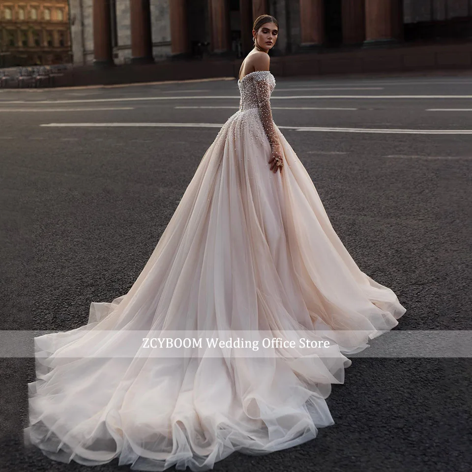 فستان زفاف فاخر مكشوف الكتفين مزين باللؤلؤ اللامع مطرز بالخرز 2025 فستان الأميرة بأكمام طويلة للنساء فساتين العروس Vestido De Noiva