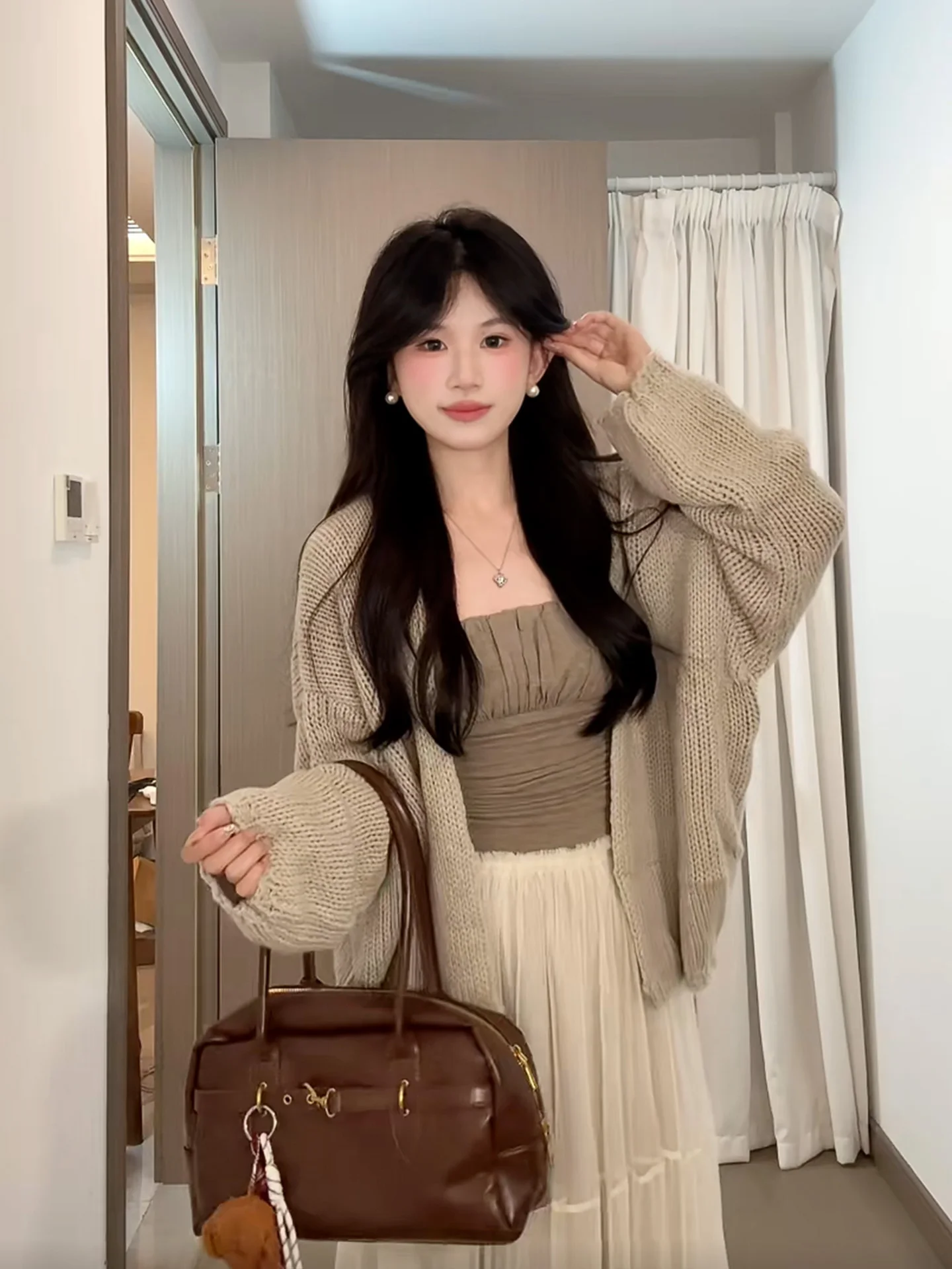 

Осенне-зимний женский вязаный комплект из трех предметов: ажурный кардиган, топ и юбка.