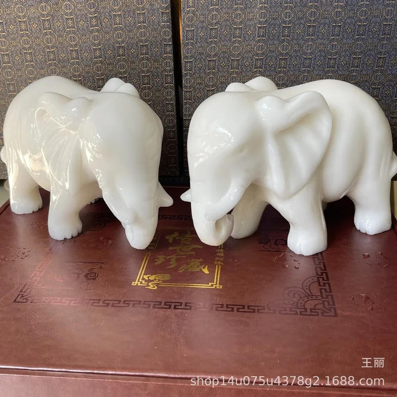 Comparable to Hetian jade, this auspicious ornament features Afghan jade with floral, bird, and elephant motifs, a Chinese-style