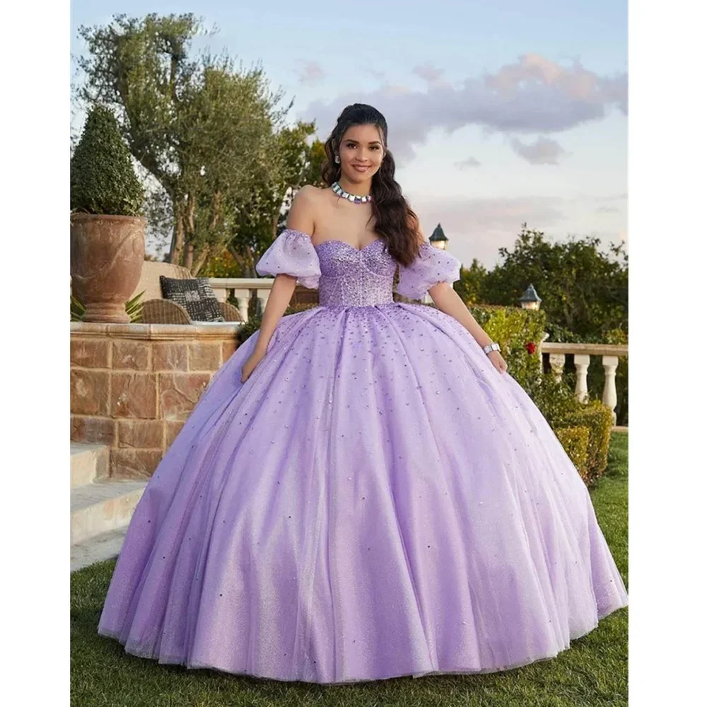 

Elegant Off the Shoulder Tulle Ball Gown Prom Dress 2024 Stunning Puffy Sleeves and Floor Length Design for Evening Events.