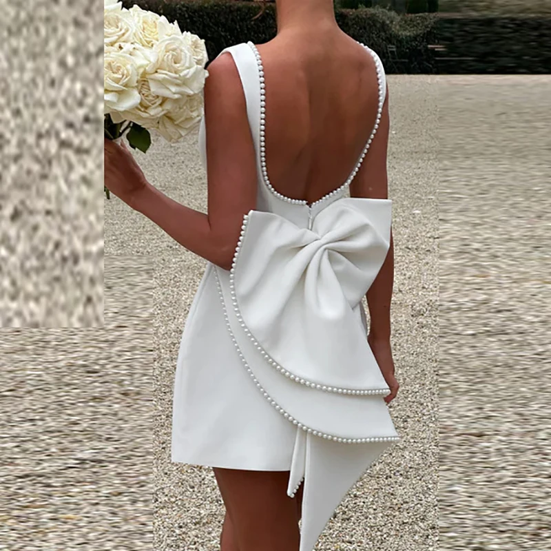 2025 Primavera Estate Decorazione con fiocco Abito da donna Cocktail Hollow Backless Solid Mini abito Elegante abito da festa senza maniche a vita