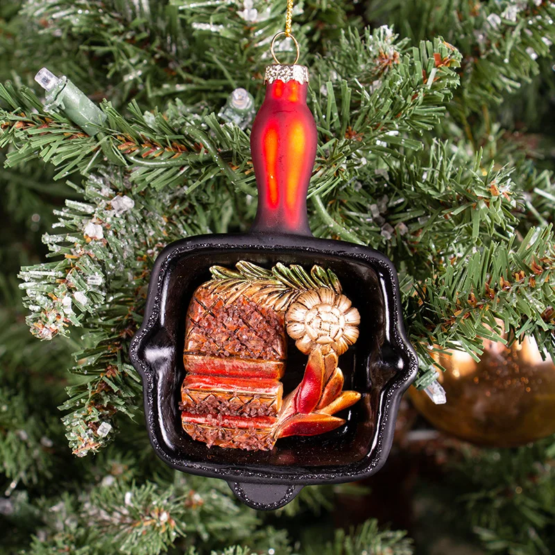 Two Christmas glass ornaments with flat bottomed pans