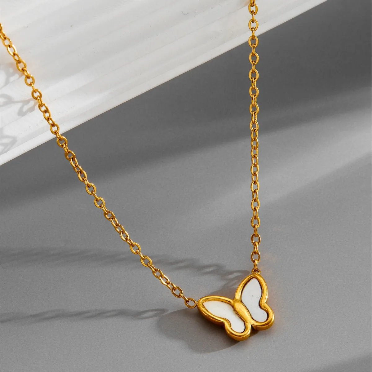 Titanium Steel Cross Chain Necklace with Delicate 925 Silver Butterfly Pendant Featuring Natural White Shell Accents in Gold or
