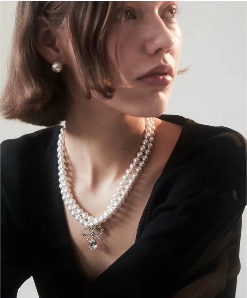 

Light luxury, high-end sense, fashionable temperament, bow knot, water drop inlaid diamond pearl necklace