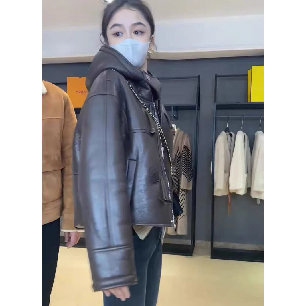 2025 Nuovo Autunno Inverno Moto Giacca in lana d'agnello Capispalla Abbigliamento da donna Fibbia ad angolo Allentato Breve Giacca in pelle calda con cappuccio Top