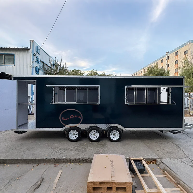 

The outdoor food trailer creates a cold industrial style with its black rectangular body