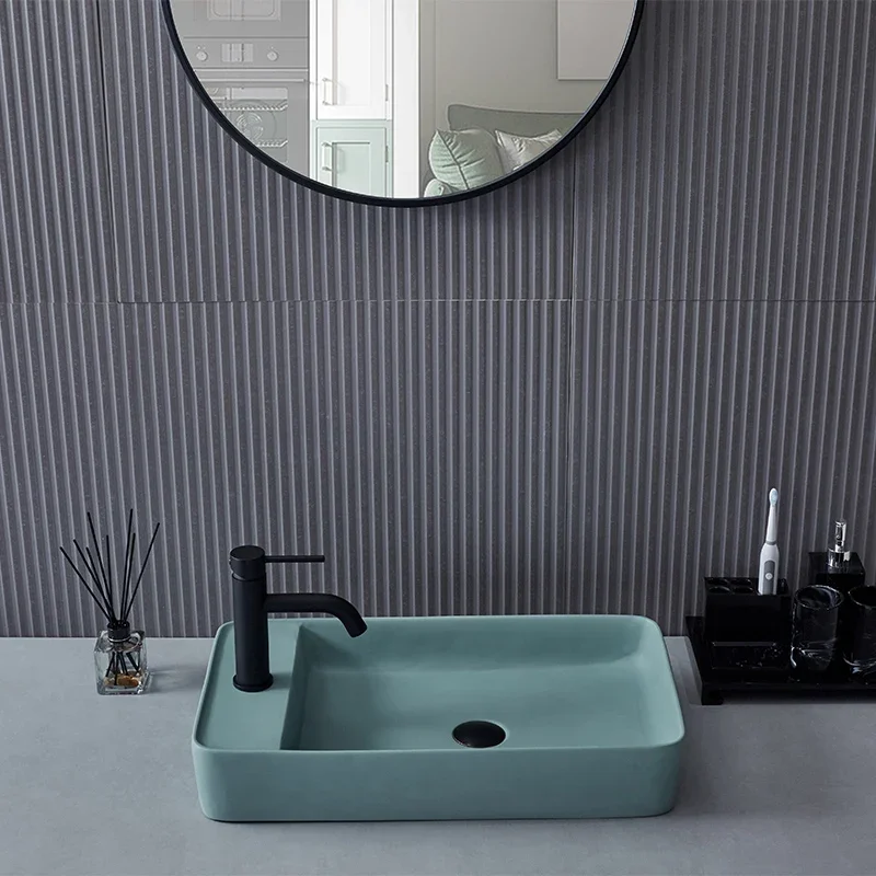 Green matte wash basin with artificial stone art basin on the counter, square shape for household bathroom