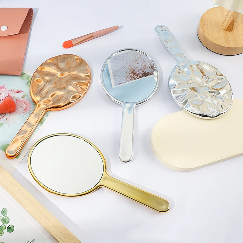 Vloeibare ellipsofvormige spiegel Handbediende desktop cosmetische make-upspiegel Reizen Draagbare schoonheid Glanzende zilveren spiegel voor handtas