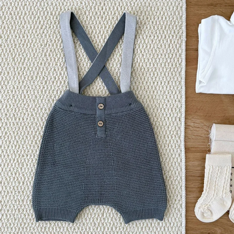 جديد ربيع 2026 بدلة قفز محبوكة للأطفال حديثي الولادة من الأولاد والبنات بدون أكمام بلون سادة ملابس أطفال على الطراز الكوري 0-24 متر