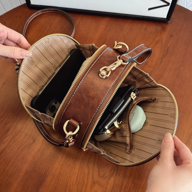 2025 بولي Leather حقيبة يد جلدية صغيرة شكل دائري حقيبة كتف الكرتون الطباعة حقيبة كروس الجسم العلامة التجارية تصميم حقيبة مقبض قصير للنساء