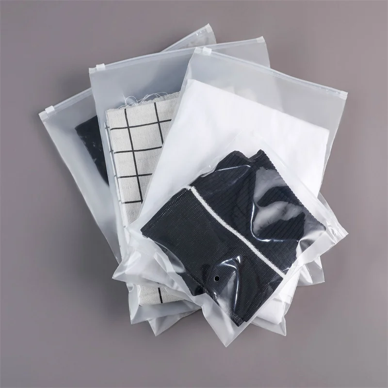 StoBag 50pcs Wholesale Frosted Transparent Clothes Zipper Package Bags Shirt Storage Plastic Clear Pouches Travel Organizer Logo