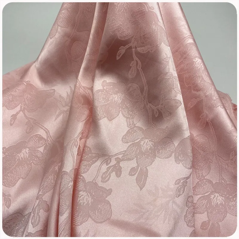 The new floral imitation silk jacquard fabric features a soft and comfortable luster making it suitable for skirts evening gowns