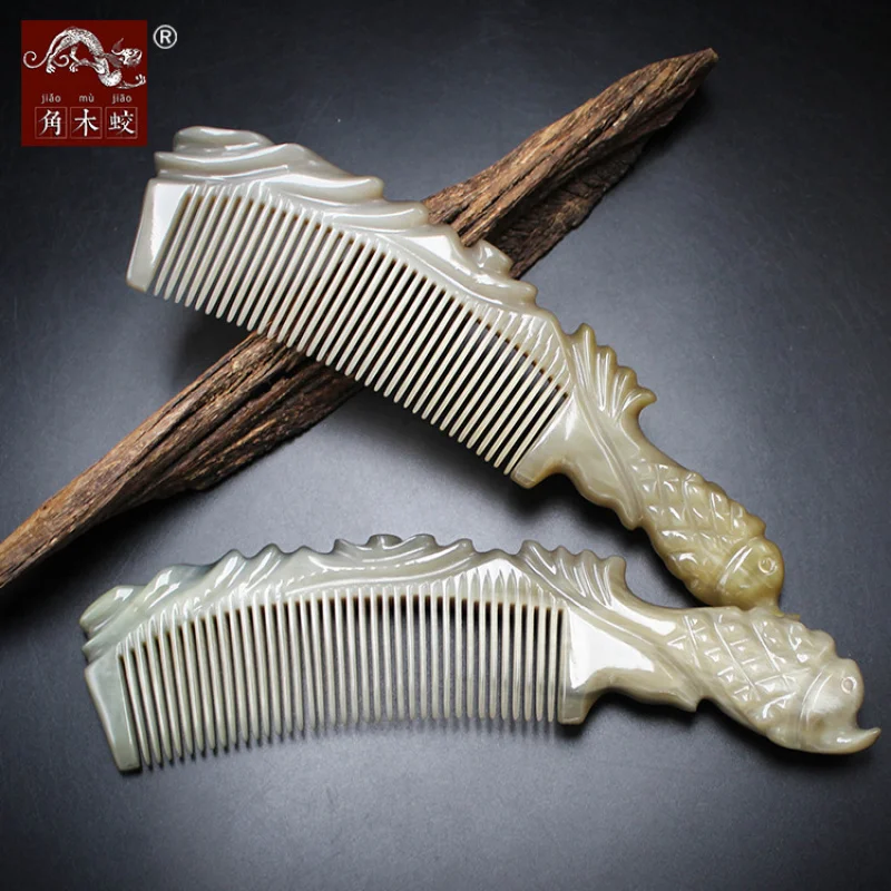 Carved fish-shaped comb made from hornwood and yak horn
