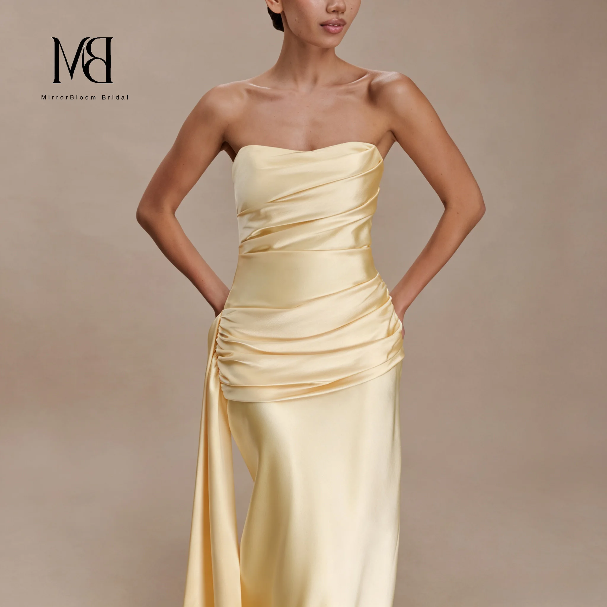Yellow off-the-shoulder sleeveless fish-tail floor-length formal evening dress with flowing pleats revealing the back