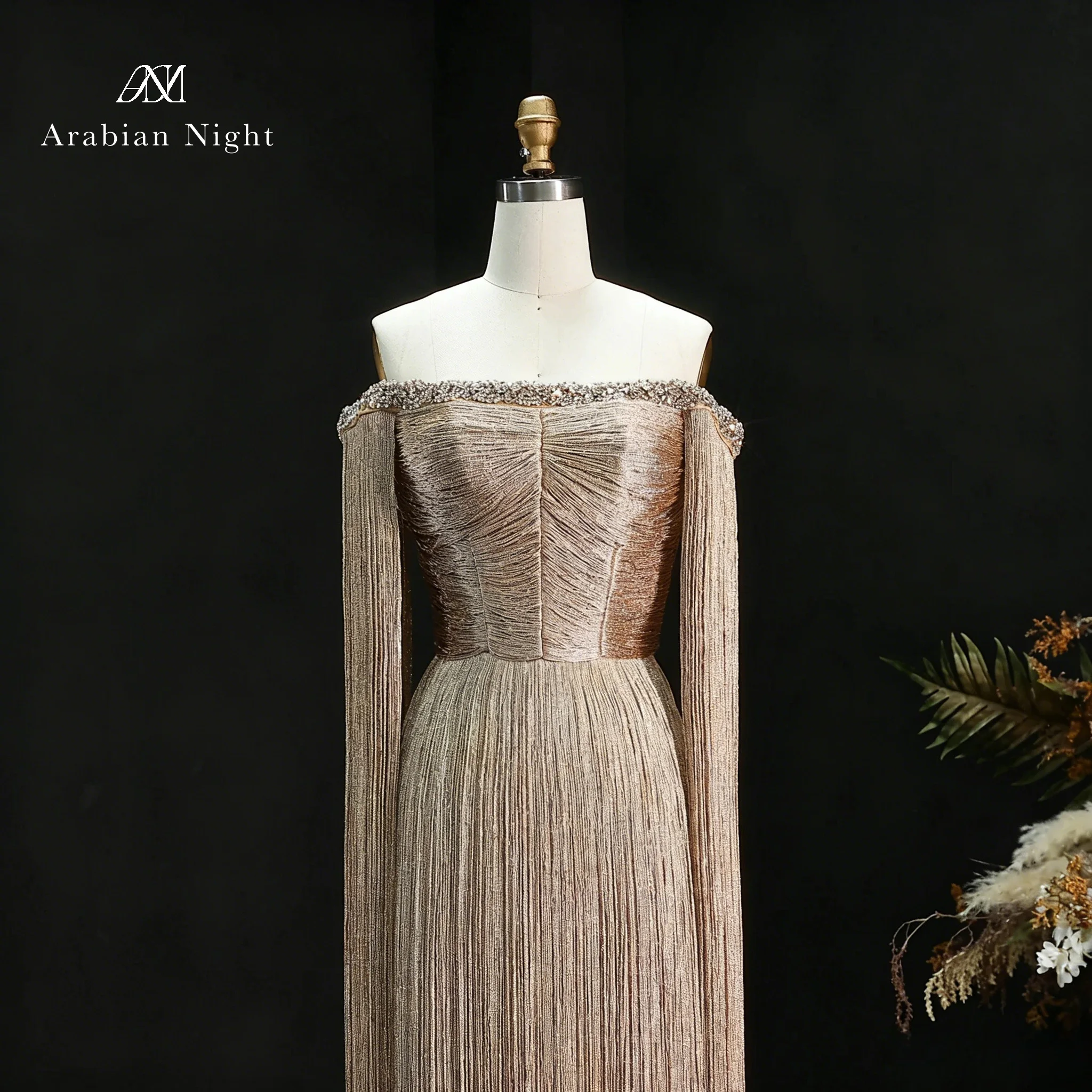 Glamorous champagne off-the-shoulder strapless sleeveless floor-length formal gown featuring a metallic fringe design