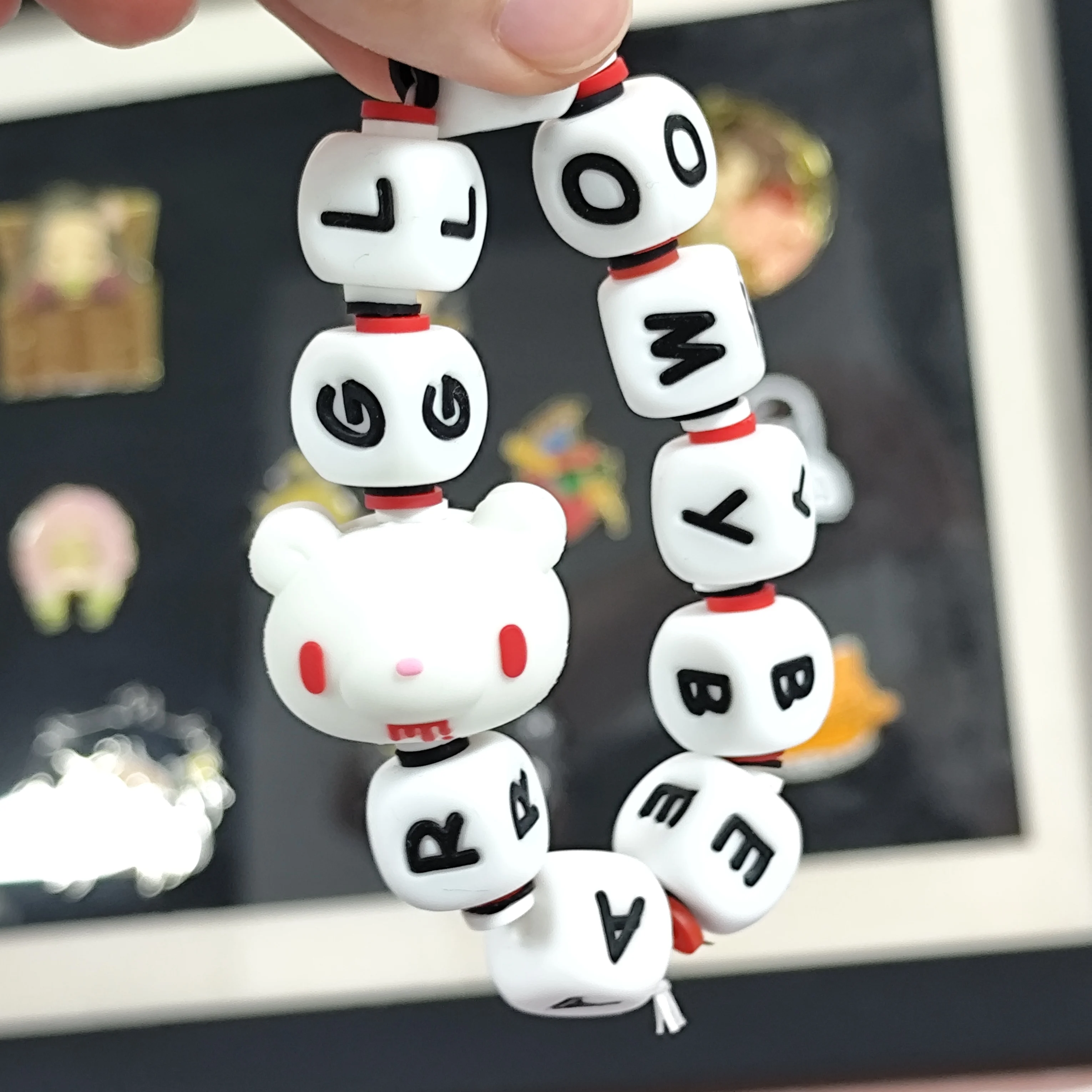 Fluorescent Gloomy Bear bracelet. White beads spell 