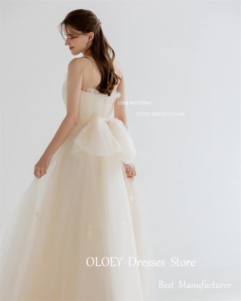 Oloey Fairy Tulle A line เดรสแต่งงานเกาหลีสำหรับถ่ายภาพชุดเกาะอกโบว์ผูกติดอยู่กับสวนชุดเจ้าสาวความยาวตั้งพื้นตามสั่ง