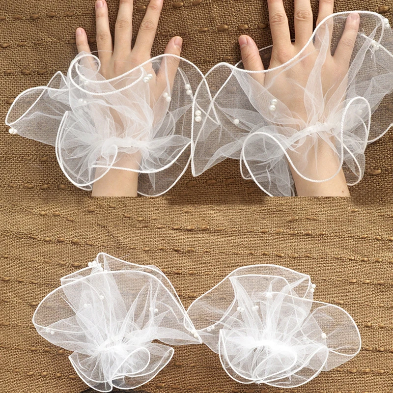 A short pearl tulle roll-up edged beaded bridal glove for a summer wedding ball party worn elegantly with fingerless sleeves