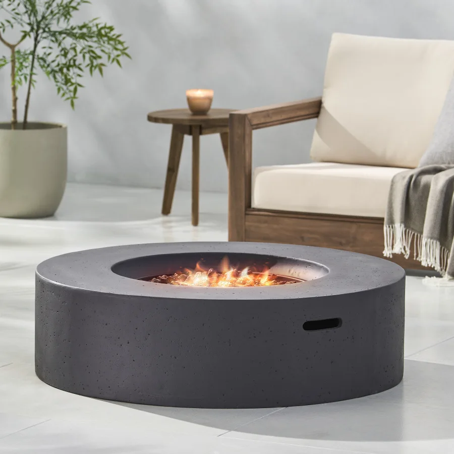 

Outdoor circular fire pit with lightweight concrete construction, dark gray finish, 50, 000 BTU output for efficient heating an