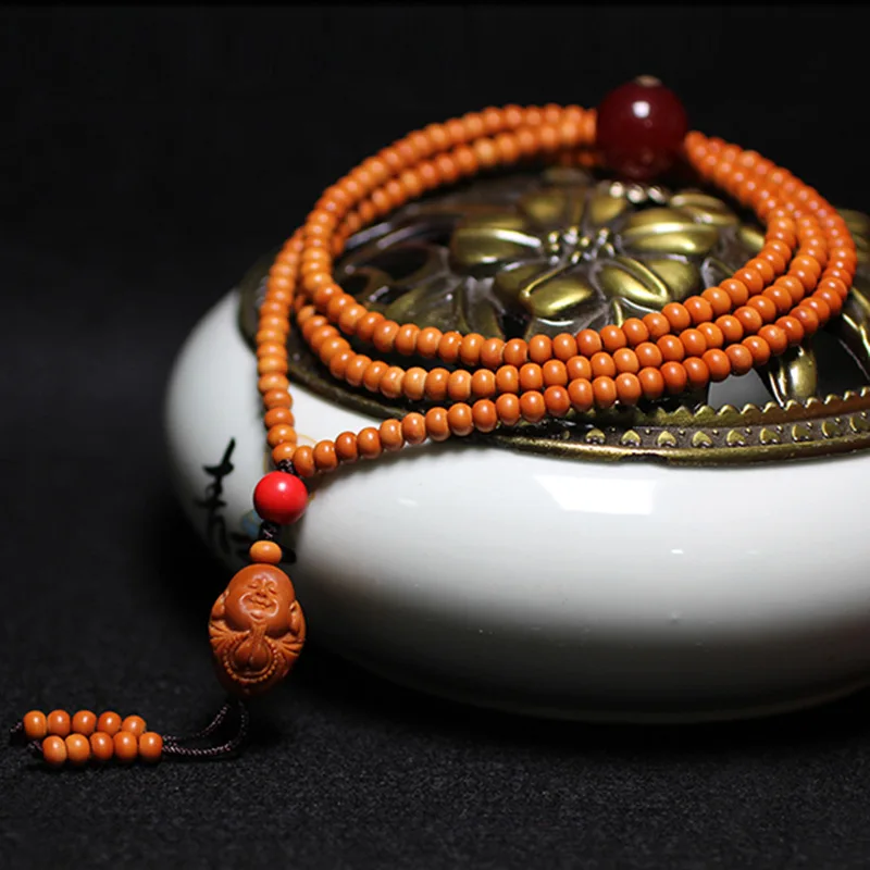 apple bead necklace. The olive pit is carved into a 