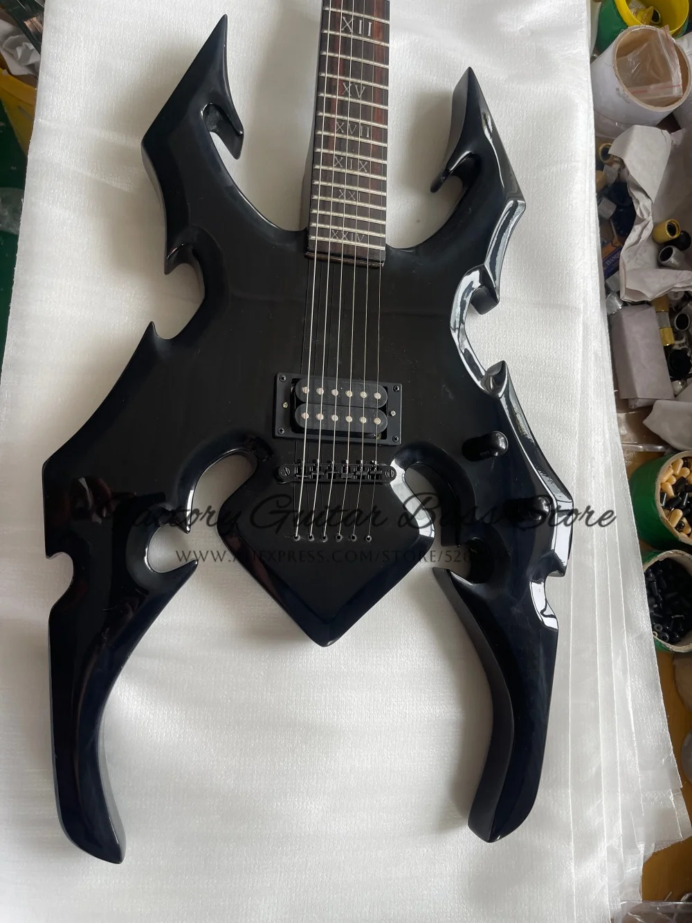 Custom black guitar, spider guitar, Roman numeral inlaid fingerboard, fixed bridge, H pickups, black tuners