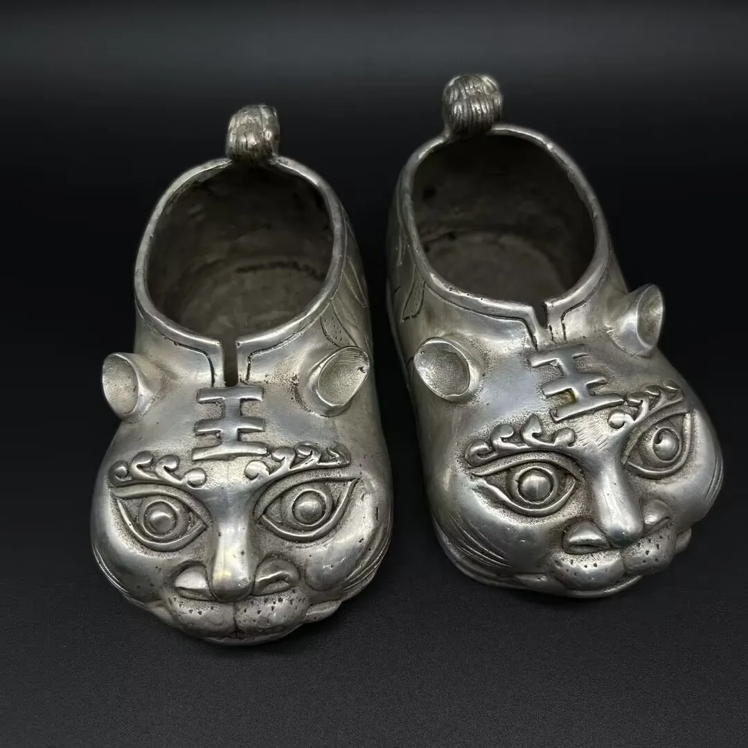 

Collection of Chinese feng shui decorative white bronze tiger-head shoes