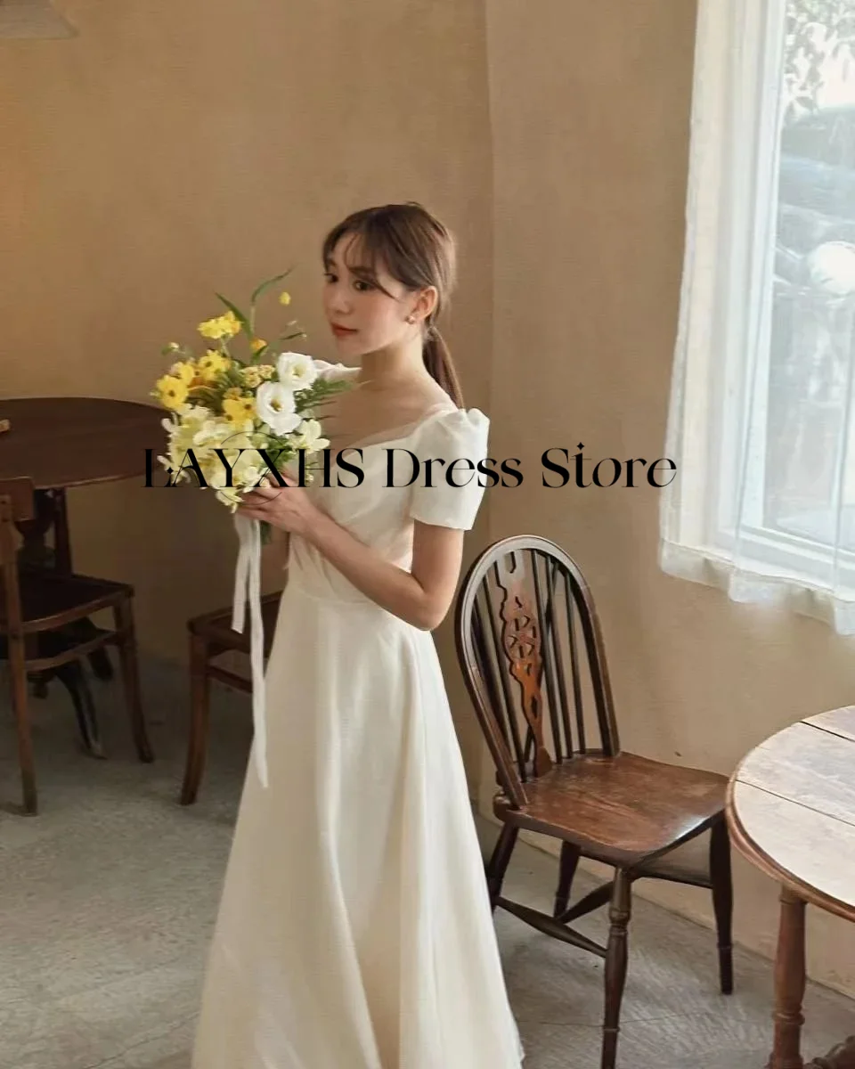 ชุดแต่งงานผ้าซาตินสีงาช้างเรียบง่ายสไตล์เกาหลี ทรงเอ แขนสั้น คอวี ยาวถึงข้อเท้า สำหรับถ่ายภาพ ชุดเจ้าสาวสั่งตัดได้