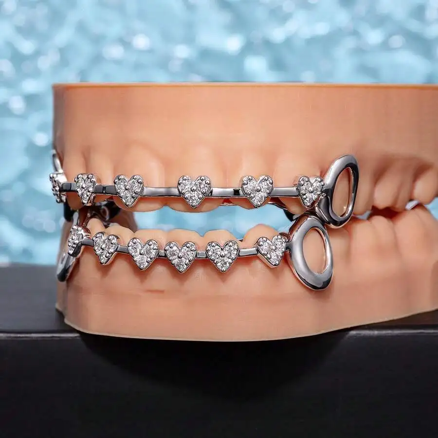 

2-Piece Heart-Designed Hollow Grillz With Copper Frame And Zirconia Stones For Hip Hop Dental Fashion Accessory